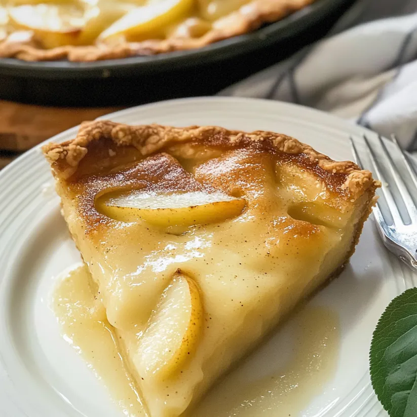 A slice of pear custard pie on a white plate.