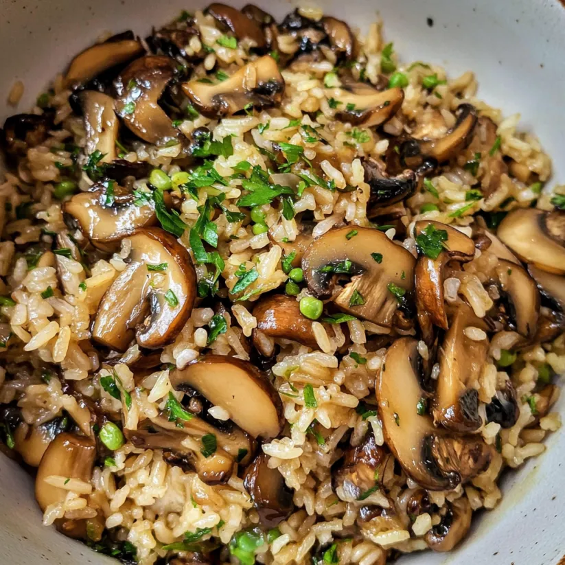 A bowl of rice with mushrooms.