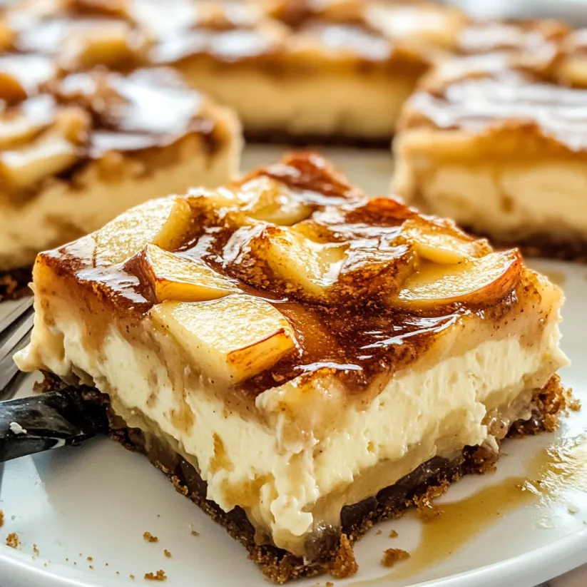 A slice of apple pie cheesecake bars.