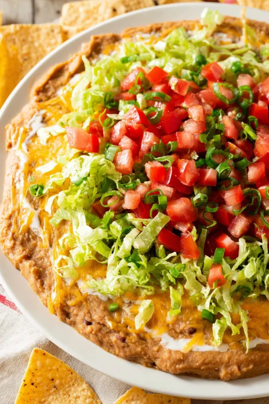 A plate of food with tomatoes, lettuce, and cheese.