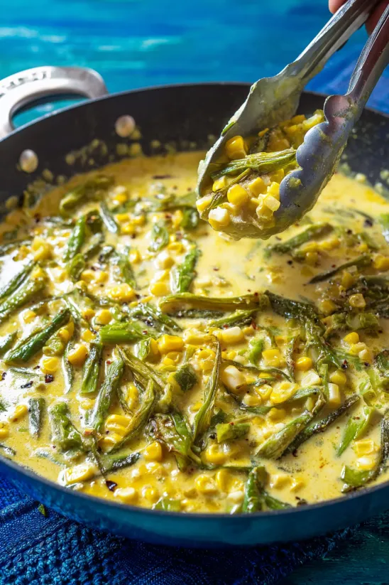 A spoon is scooping up Rajas Poblanas.