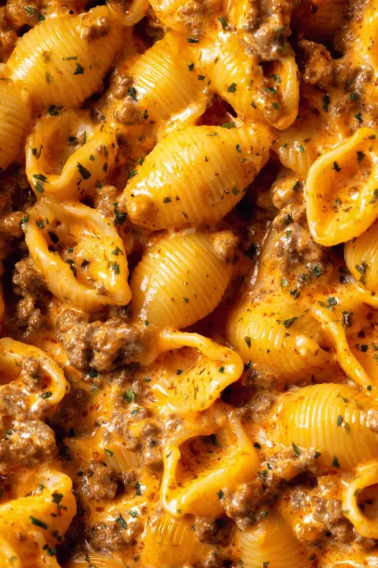 A bowl of pasta with meat and cheese.