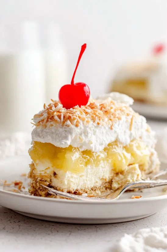 A slice of cake with a cherry on top.