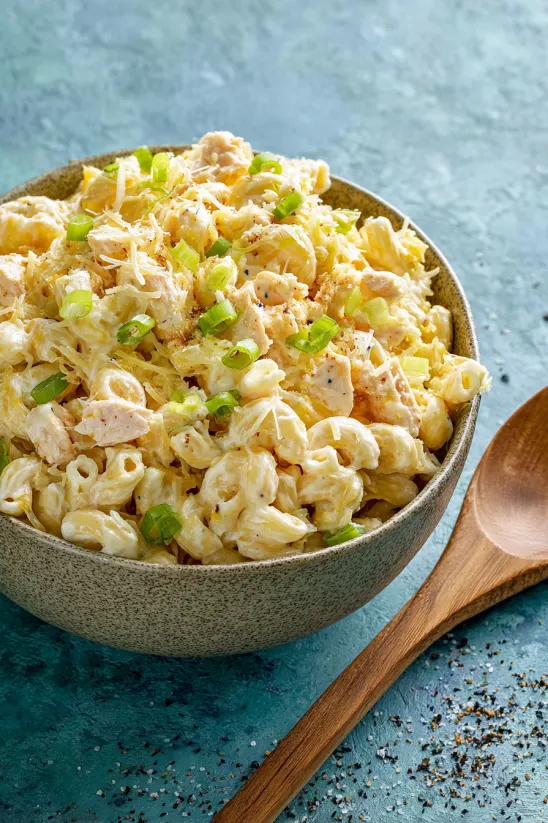 A bowl of macaroni salad with green onions.