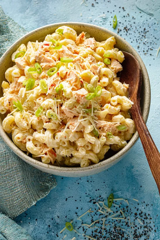 A bowl of macaroni and cheese with chicken.