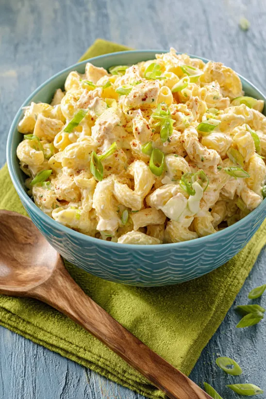 A bowl of pasta with green onions.