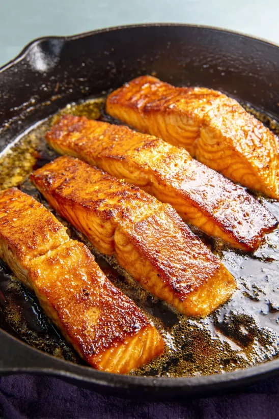 Blackened salmon in a pan.