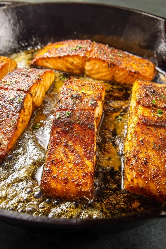 A pan of fish on a stove.