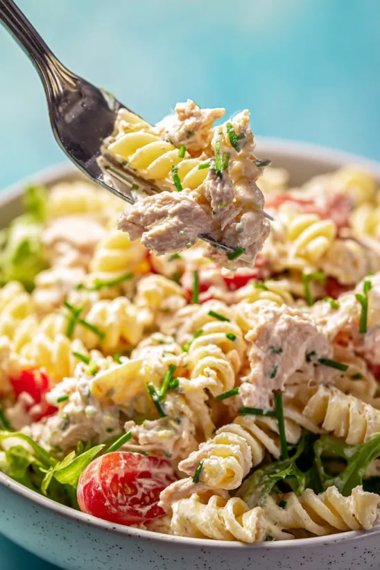 A fork is picking up a piece of food.