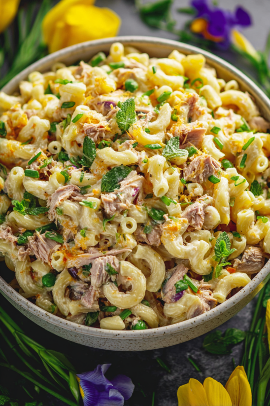 A bowl of pasta with meat and vegetables.