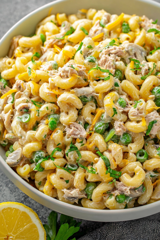 A bowl of pasta with meat and vegetables.
