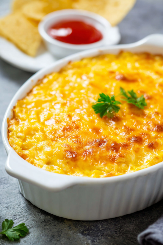 A white bowl with a casserole in it.