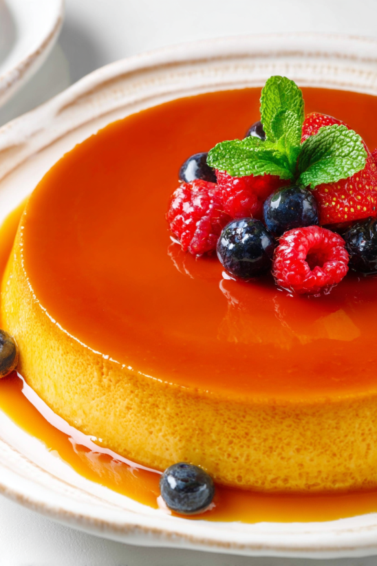 A slice of queso flan with berries on top.