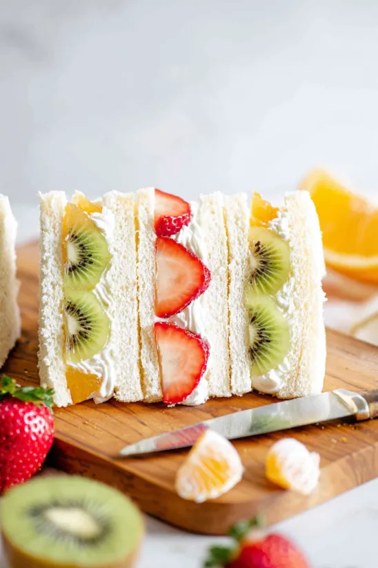 A slice of cake with kiwi, strawberry and kiwi on it.