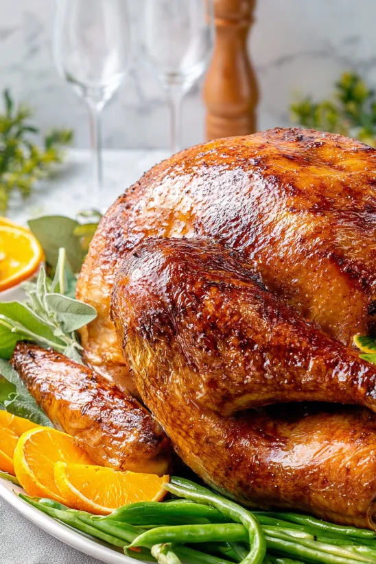 A roasted turkey with a glass of wine.