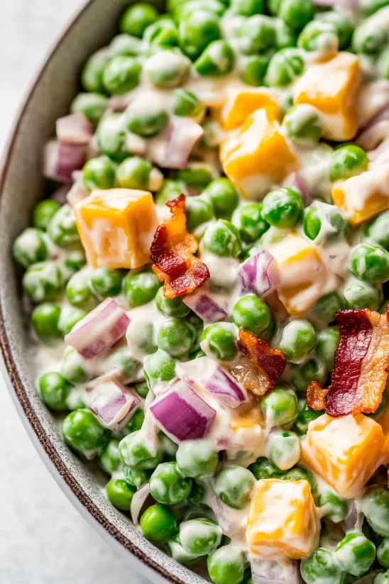 A bowl of loaded pea salad.