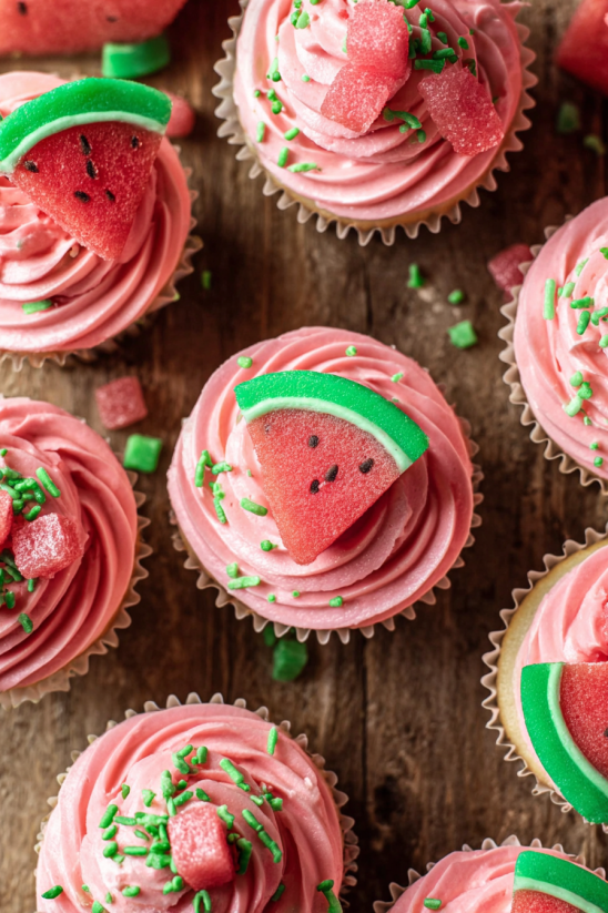 A cupcake with a slice of watermelon on top.