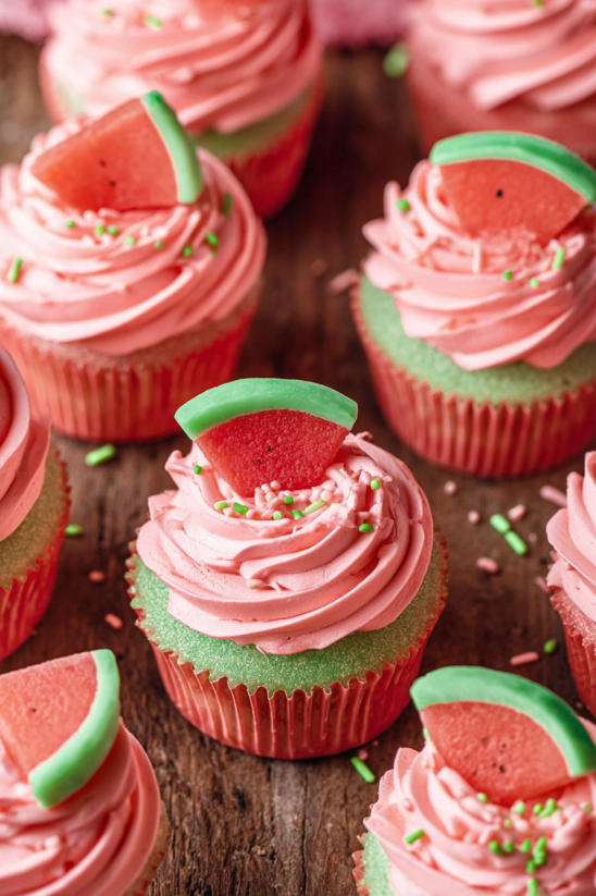 A cupcake with a slice of watermelon on top.