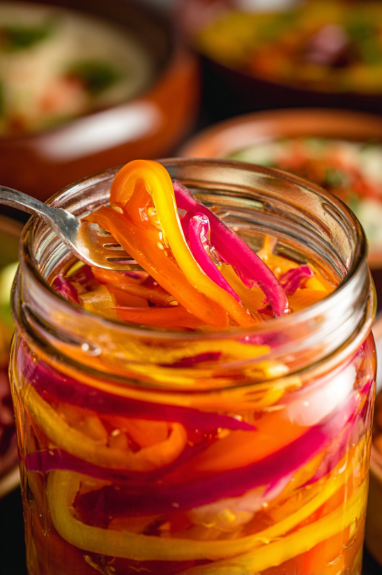 A jar of pickled red onions with habaneros.