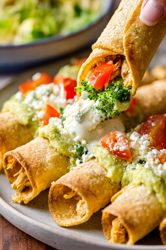 A plate of food with a burrito and a bowl of salsa.