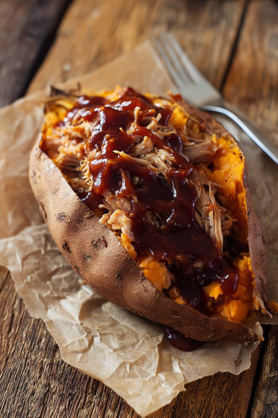 A sweet potato with pulled pork in it.