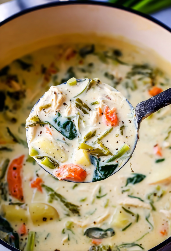 A spoon is in a bowl of soup.