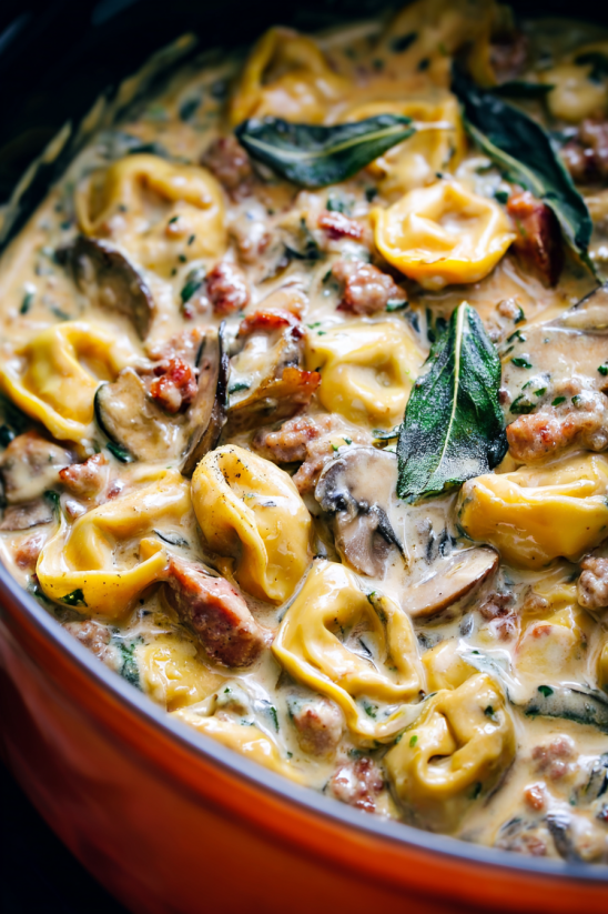 A bowl of pasta with mushrooms and meat.