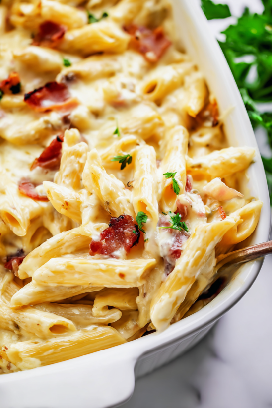 A bowl of macaroni and cheese with ham.