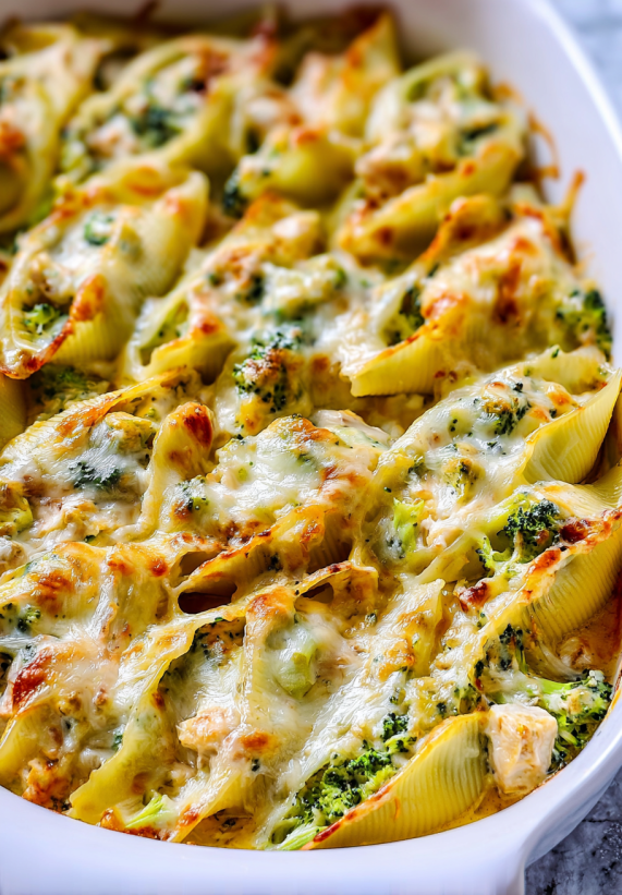 A dish of pasta with broccoli and cheese.