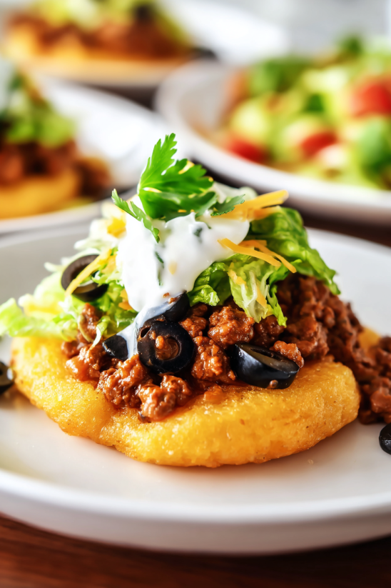 A plate of food with a burrito on top.