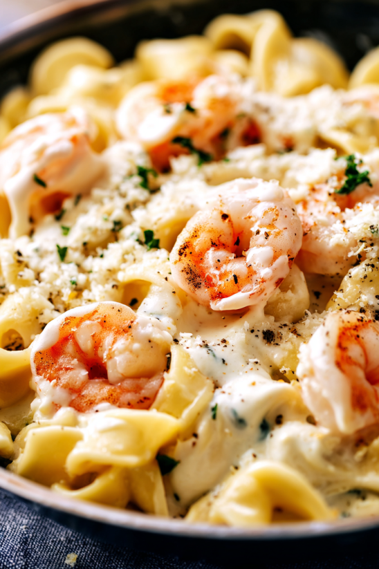 A bowl of shrimp and pasta.