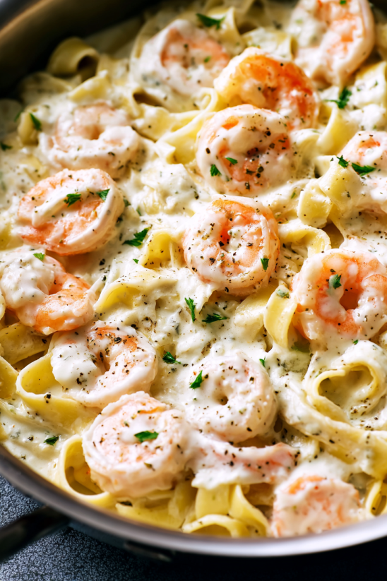 A bowl of shrimp and pasta.