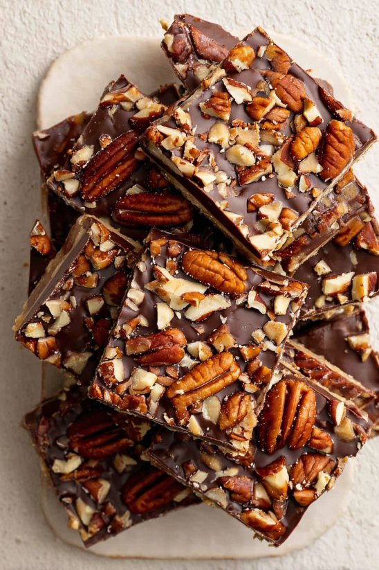 A close up of a piece of chocolate cake with nuts.