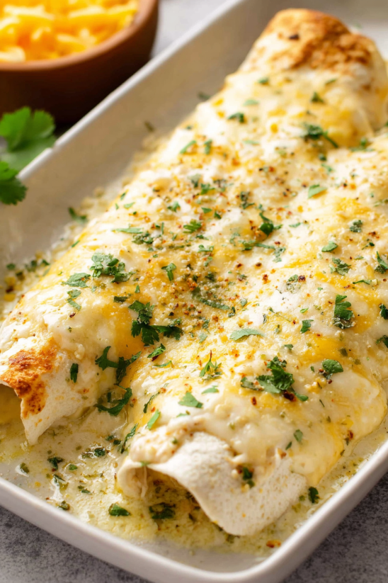 A dish of food with a white sauce.