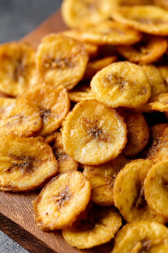 Plantain chips on a wooden table.