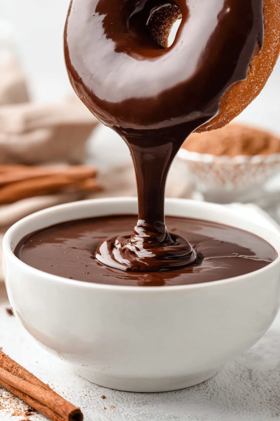 A chocolate sauce is being poured into a bowl.