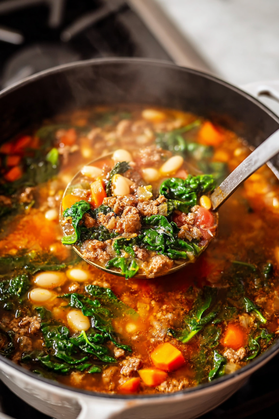A spoon is in a bowl of soup.