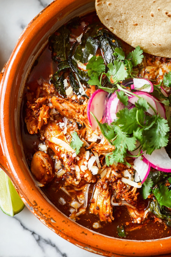 A bowl of food with a slice of lime on top.