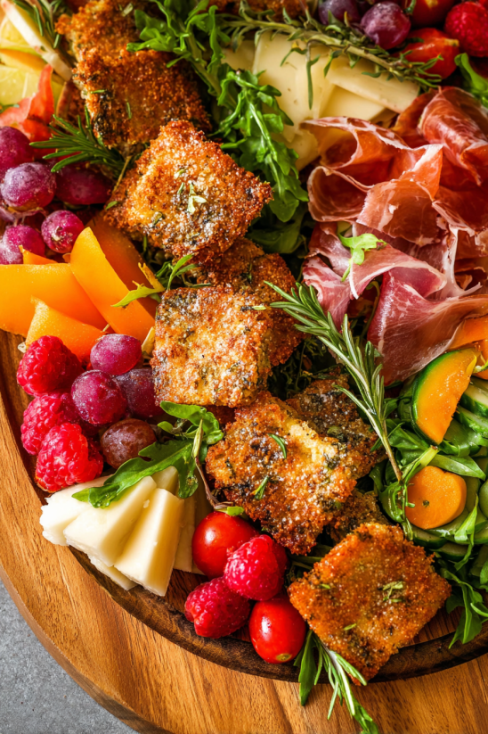 A plate of food with meat, cheese, and vegetables.