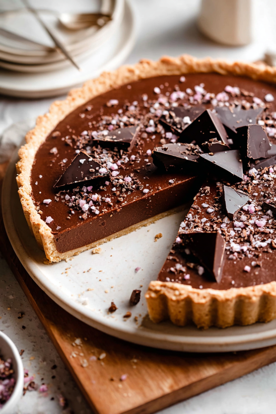 A slice of chocolate cake with chocolate chips.