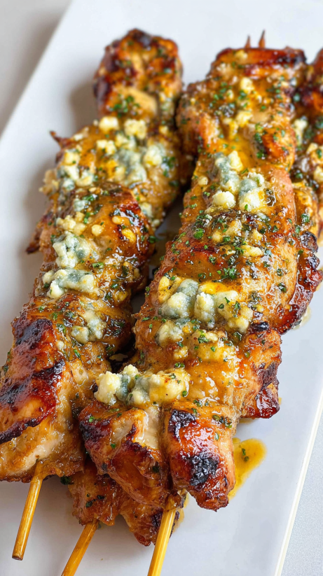 Skewers of meat with a blue cheese sauce.