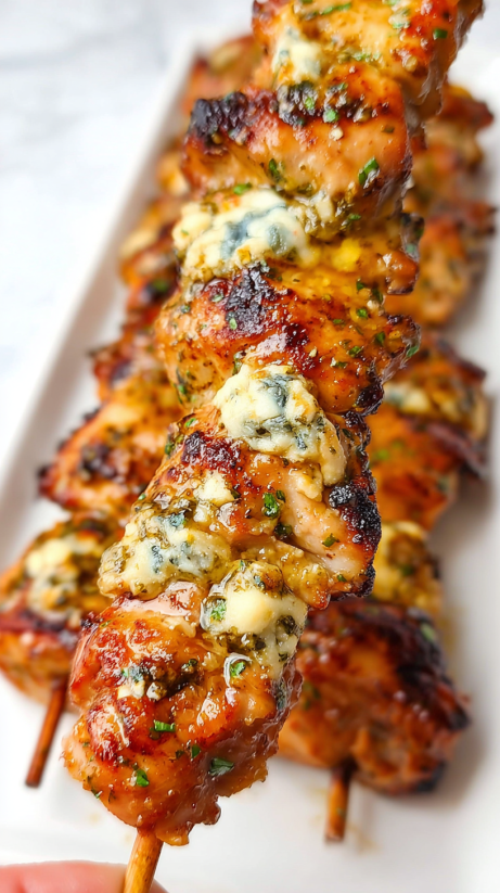 Chicken with blue cheese on a white plate.