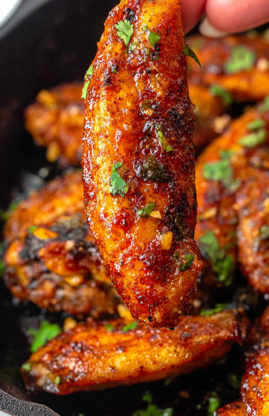 A close up of a piece of garlic butter chicken.