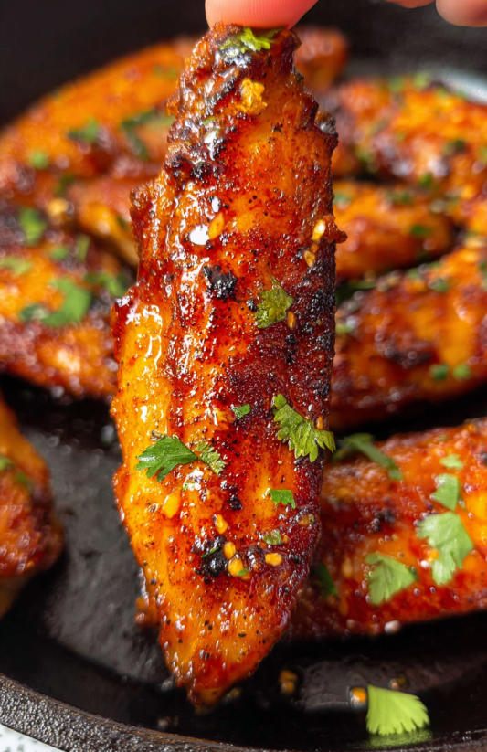 A close up of a piece of garlic butter chicken.