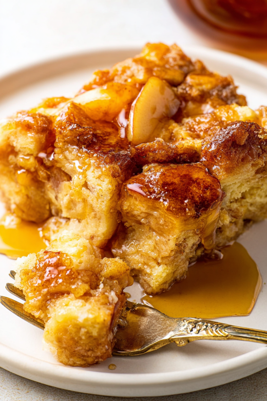A piece of cake with syrup on a plate.