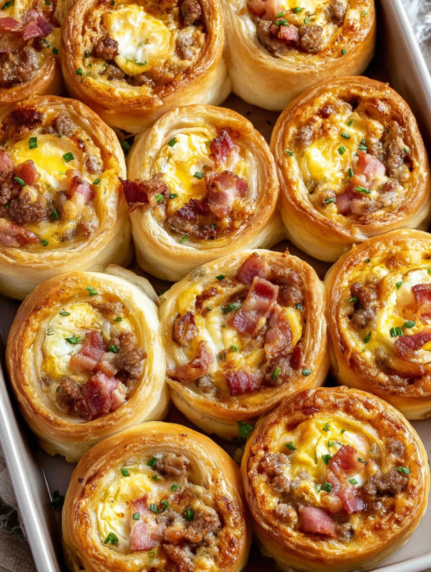 A tray of breakfast rolls with bacon and cheese.