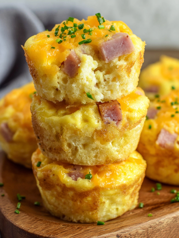 Three stacked ham and cheese egg muffins.