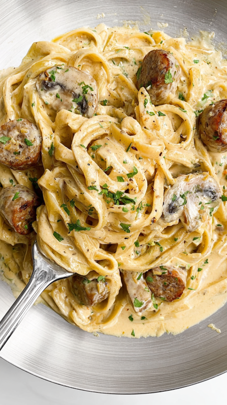 A plate of garlic butter steak with parmesan alfredo.