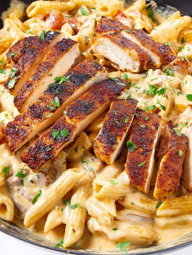 A dish of pasta with chicken and sausage.