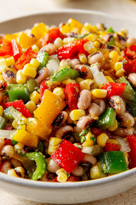 A close up of a salsa with black beans and corn.